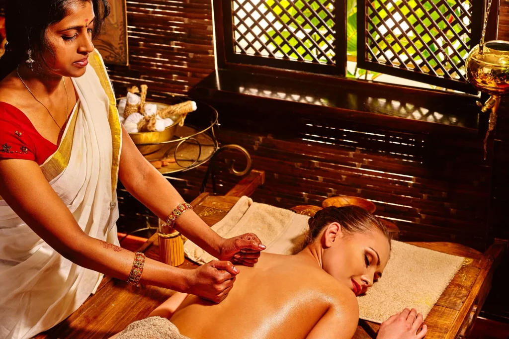 A woman lying down and enjoying ayurvedic massage