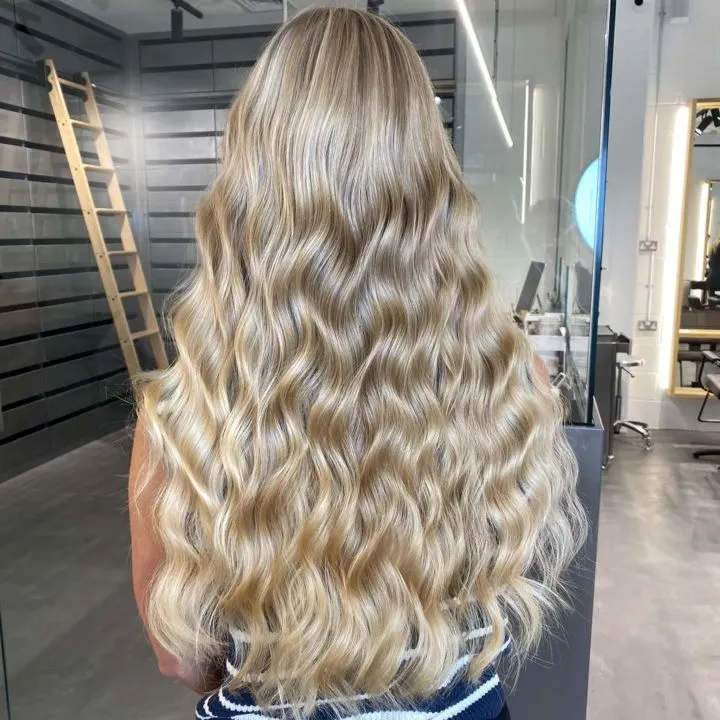 Blonde woman with mermaid hair cut.