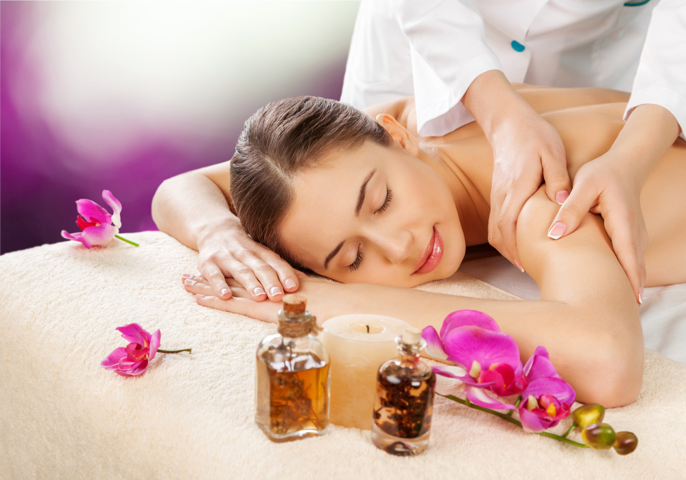 Beautiful lady getting aromatherapy massage in spa usinf essential oils in aromatherapy