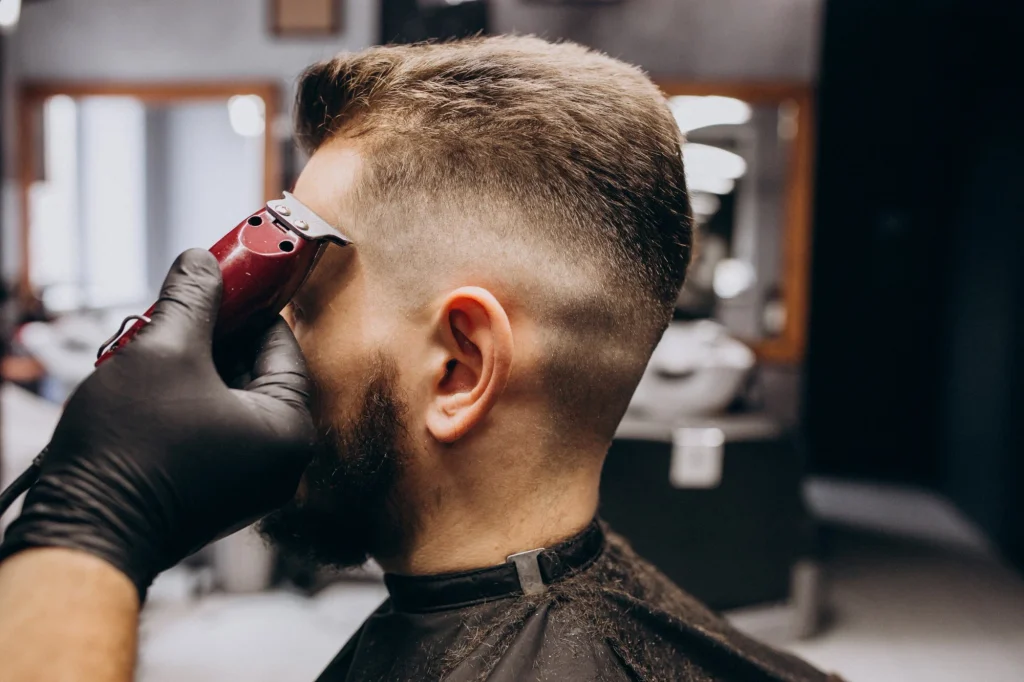 A man getting fade cut at salon