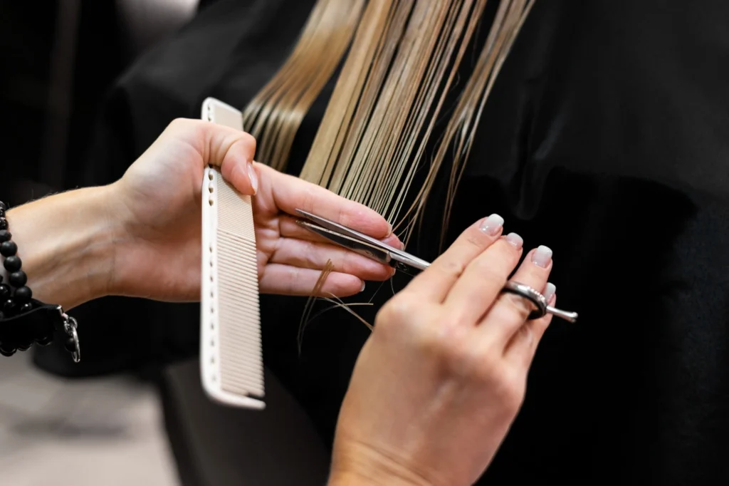 A woman getting hair trim at a salon